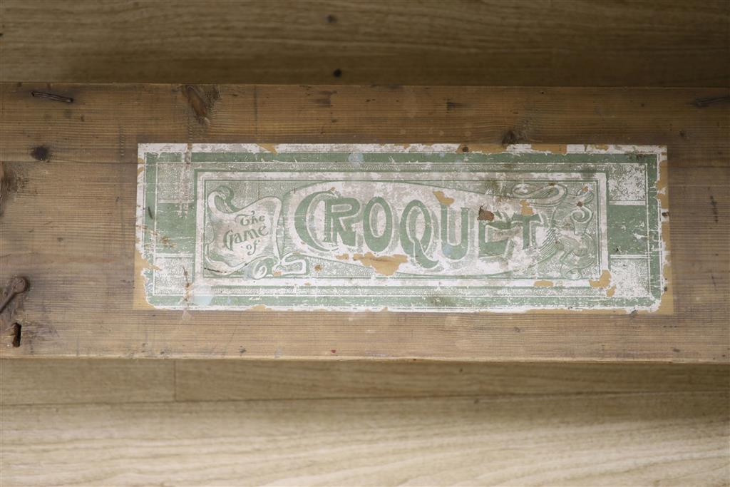 An early 20th century pine cased croquet set